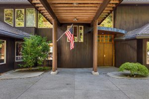 Under the portico facing entry