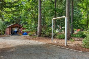 Beginning of circular drive, bird feeders on the right, boat/RV storage and quonset shop barely visible in the background.
