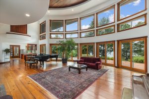 The Great Room has plenty of space for a concert grand piano, furniture, plants, dining and entertaining. The high ceiling creates great acoustics for live music. During nicer weather, the spectacular view of Puget Sound draws people through the multiple sliding doors onto the brick patio for dining, morning coffee, or just relaxing.