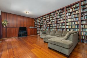 The media room has a wall of adjustable shelves for videos, books, games or displays of any sort, with cabinets and space for TV and media center at the far end. Plenty of room for couches, chairs, tables or activities. This room would also make a great main floor office – a door could even be installed in the outer wall for a private entrance.