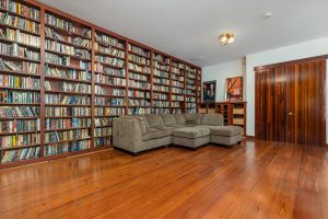Media room shelving and sectional couch leaves massive room for the rest of the furniture