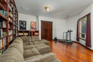 Entrance to the media room comes from a door off the main hallway, across from the hall coat closet, and next to the powder room. The owners kept a variety of exercise equipment in the nook.