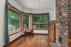 Set at a 45 degree angle from the sleeping space, this sitting area facing the deck and patio on one side, fireplace on the other, is a favorite spot for humans and cats or dogs to snuggle and watch the wildlife.