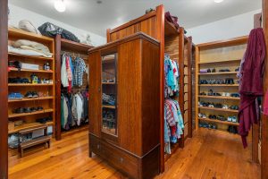 Master closet boasts custom drawers, shelves and hanging closets on every wall and both sides of the center structure.