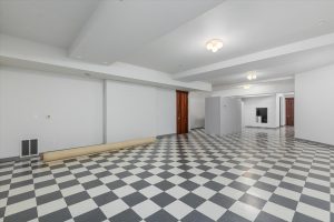 The landing area at the bottom of the stairwell leads to an enclosed finished space of about 1420 square feet. The owner used as a photography studio, with space behind the non-bearing walls for shelving and storage. A perfect space for a pod-casting sound studio, media/game room, craft area, or a separate private living area for adult children or parents. No end to the uses for this room.