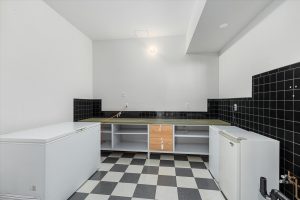 The former dark room, plumbed for film developing, could easily be converted to a kitchenette to create a complete living space in the daylight basement.