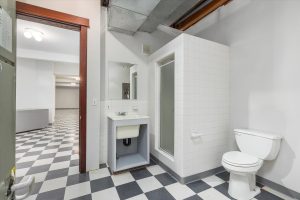 In this view of the north mechanical room, you can see the toilet, tiled shower stall and deep sink. Should you decide to convert the lower level to a separate living area, you might want to replace it with a typical bathroom sink and counter. Not visible are the heat pump and circuit breaker panel on the back wall.