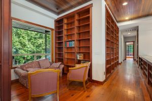 Rows of built in book shelves adorn the walls of the upper hallway. Enjoy the cozy reading nook while settling in with a cuppa and a book or magazine.