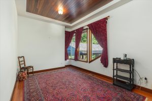First upper level bedroom with east facing windows, showing portico.