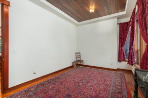 First upper level bedroom with windows facing woods to the east