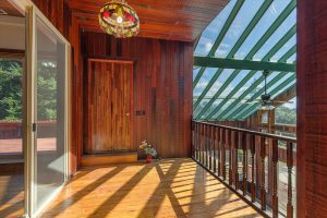 This inside upper deck, which overlooks the solarium, adjoins the second upstairs bedroom and outside deck. It's the owner's favorite place to take a break during the colder months.
