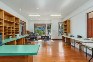 Originally intended to be a billiard or other game room, this fabulous space was immediately converted to an executive office. With picture windows facing the magnificent fig tree and Puget Sound toward Gig Harbor, it also features a sliding window looking down upon the solarium to help stay calm and focused while working. Now reduced to working on foldout tables and file boxes, this large room formerly held a desk, credenza, conference table, three lateral and one vertical file cabinet. Another versatile space with no end of uses. It could even be another bedroom, though a bit bright from all the windows.