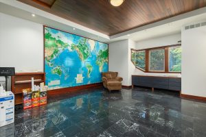 This room used as a second executive office faces north, with a window looking out toward the side lawn, shops and back field. Removable world wall map, cabinet with drawers and counter, and boxes of plans